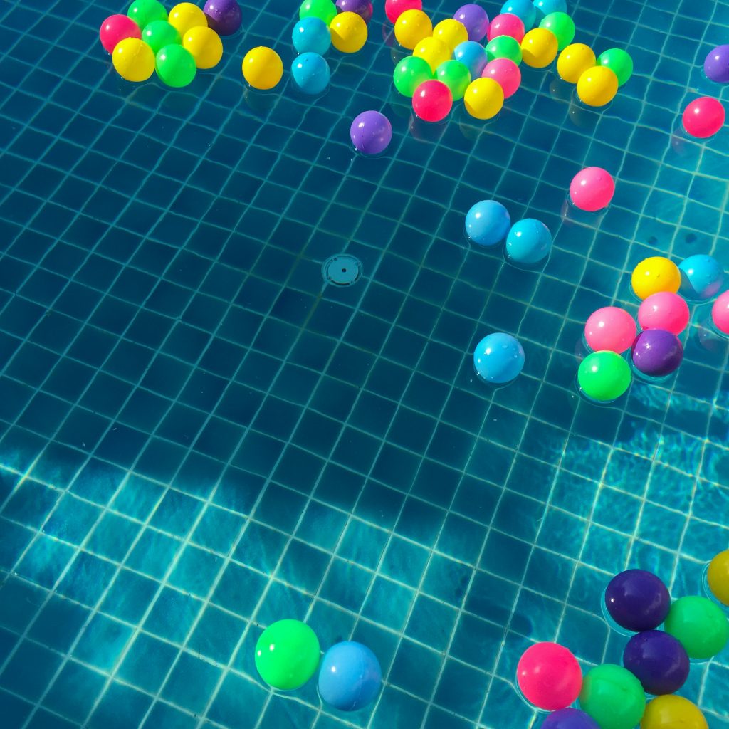 assorted-color-balls-floating-on-water-887821